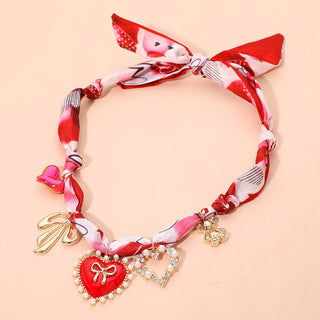 Scarf necklace with red heart charm and gold accents 
