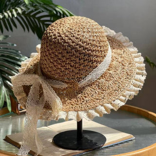 Woven straw hat with lace trim.