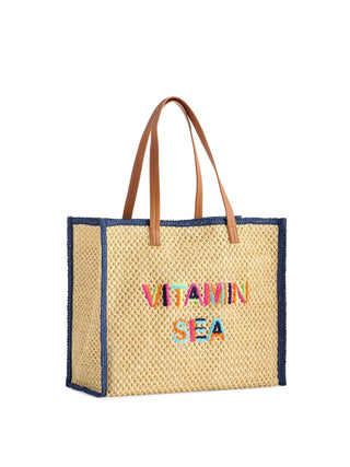 Woven tote bag with 'Vitamin Sea' text.