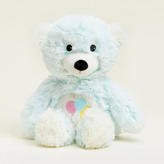 A light blue and white plush teddy bear warmie with embroidered pink, blue, and yellow balloons on its chest.
