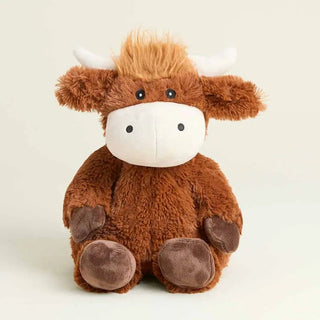 A Warmie Highland cow sitting upright. The toy features brown plush fur, a white snout and horns, and dark brown hooves.