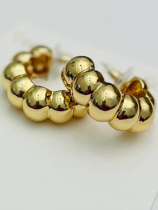 Gold bubble hoop earrings.