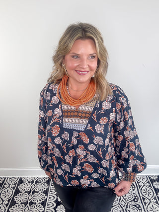 patterned orange floral blouse