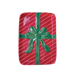 Appetizer plate decorated as a gift wrapped in red with green bow.