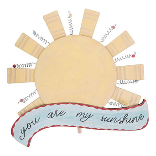 Decorative sun topper with 'you are my sunshine' written on it.