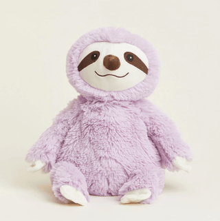 A plush purple sloth warmie with a soft texture, featuring a smiling face.
